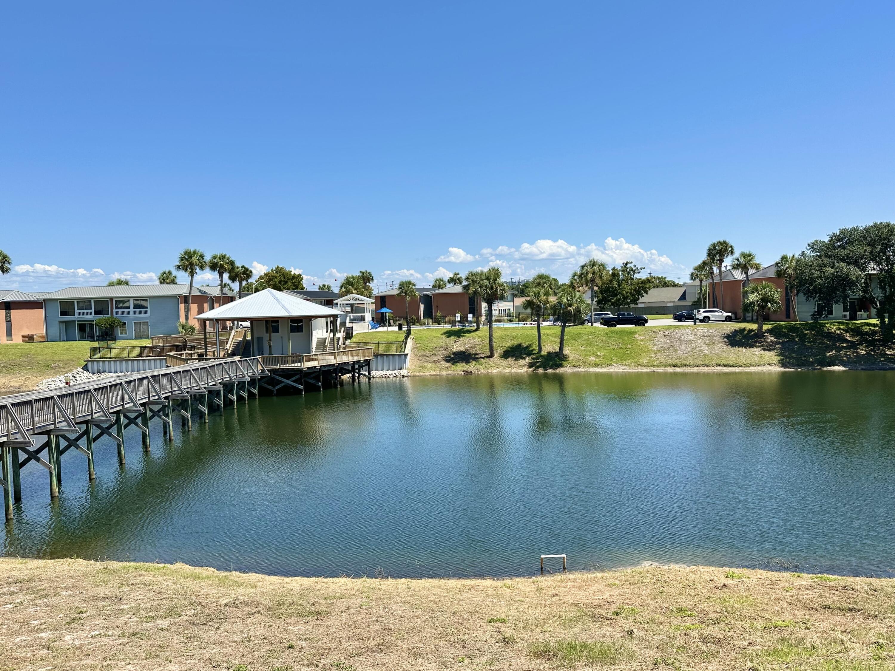 4000 Gulf Terrace Drive, Unit 2008 Destin, FL 32541 - Photo 30 of 35 a view of a lake with boats and trees in the background