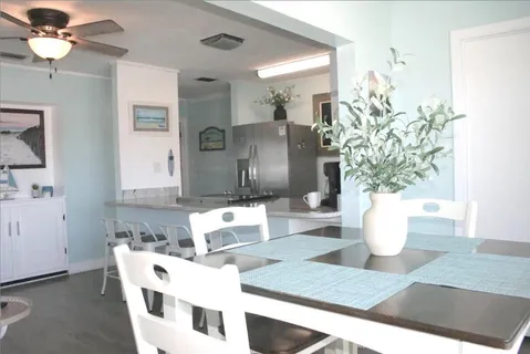 a living room with furniture a potted plant and a chandelier
