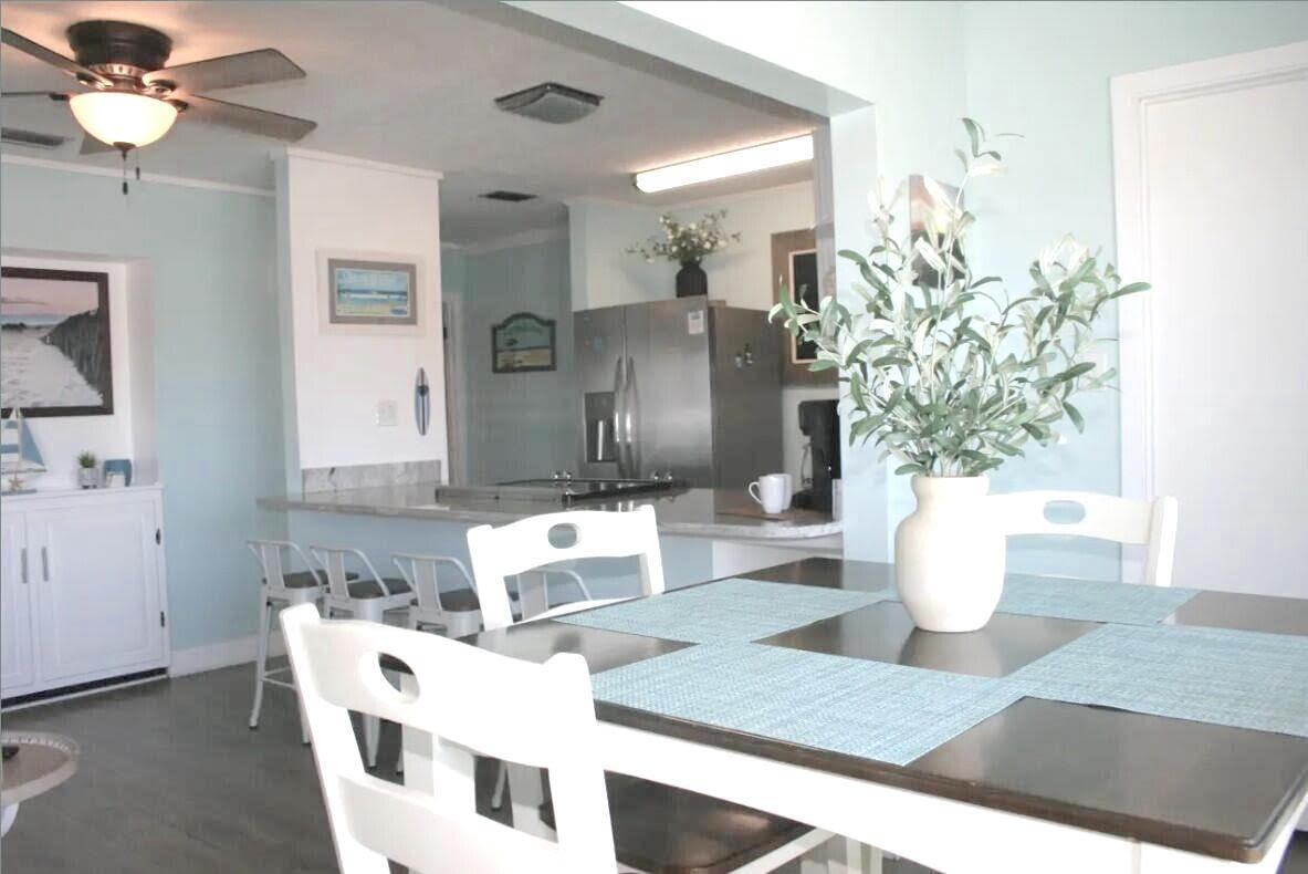 4000 Gulf Terrace Drive, Unit 2008 Destin, FL 32541 - Photo 4 of 35 a living room with furniture a potted plant and a chandelier