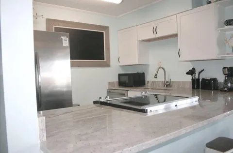 a kitchen with a refrigerator and a sink
