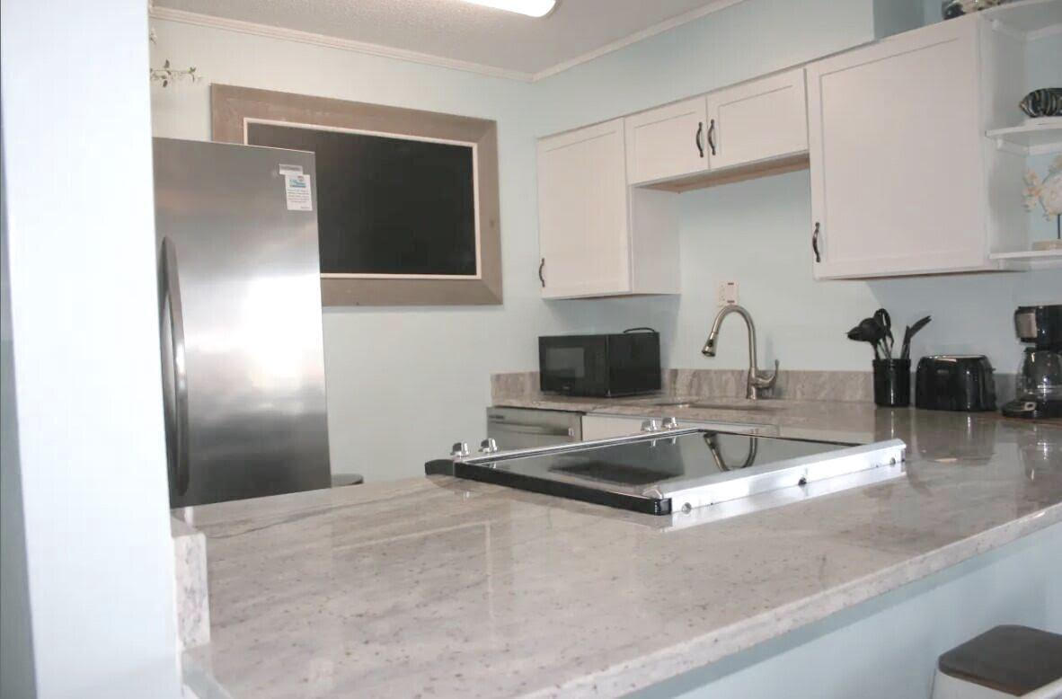 4000 Gulf Terrace Drive, Unit 2008 Destin, FL 32541 - Photo 5 of 35 a kitchen with a refrigerator and a sink