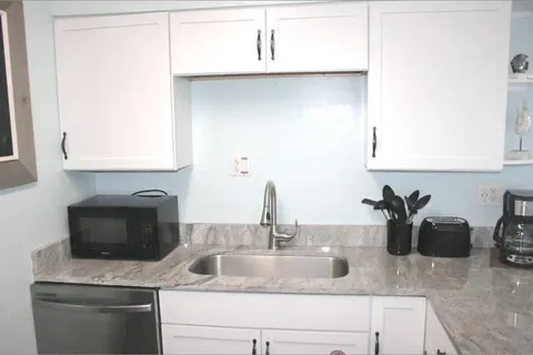 a close view of a sink and a kitchen counter space