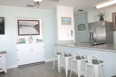a view of a kitchen with refrigerator and window