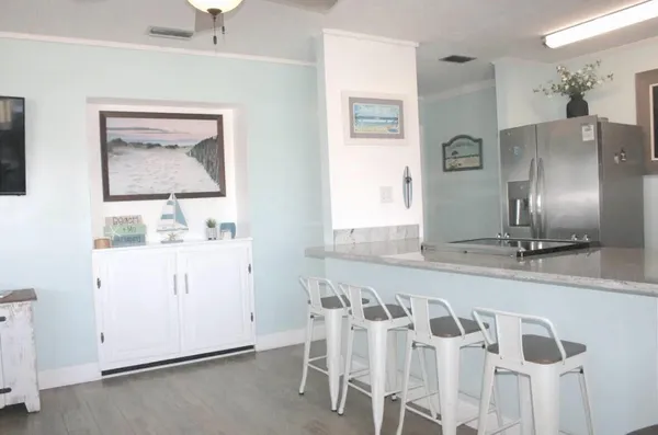 a view of a kitchen with refrigerator and window