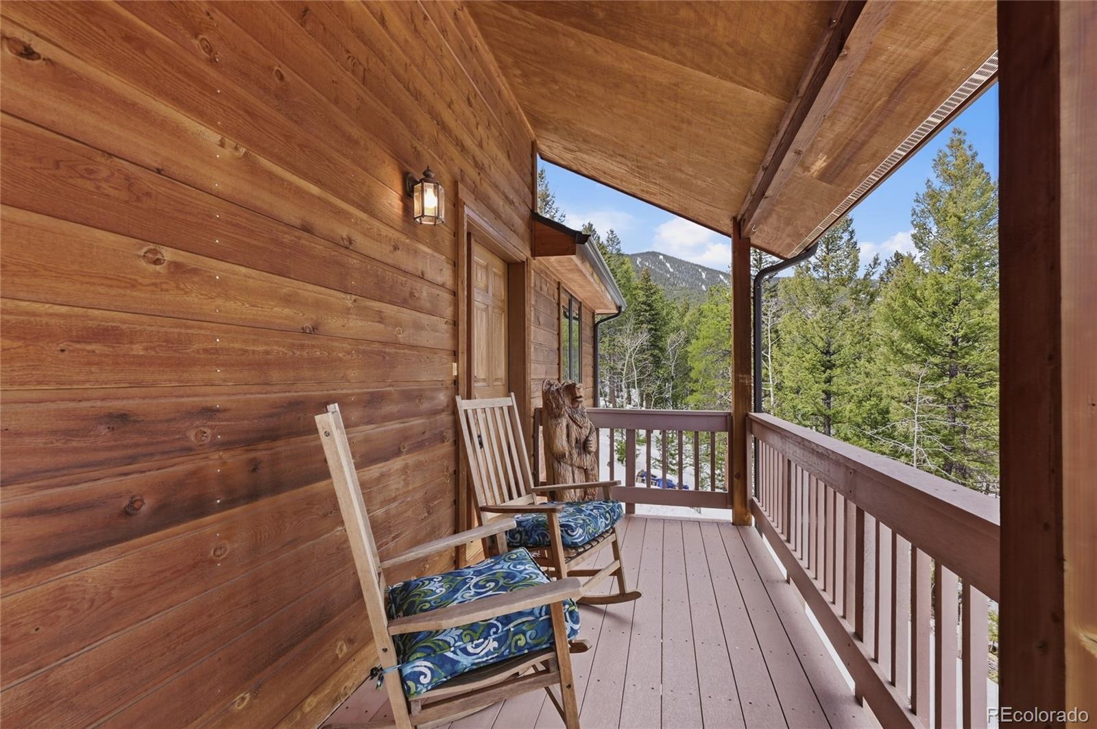 31842 Steven Way Conifer, CO 80433 - Photo 4 of 19 a view of balcony with wooden floor and outdoor seating