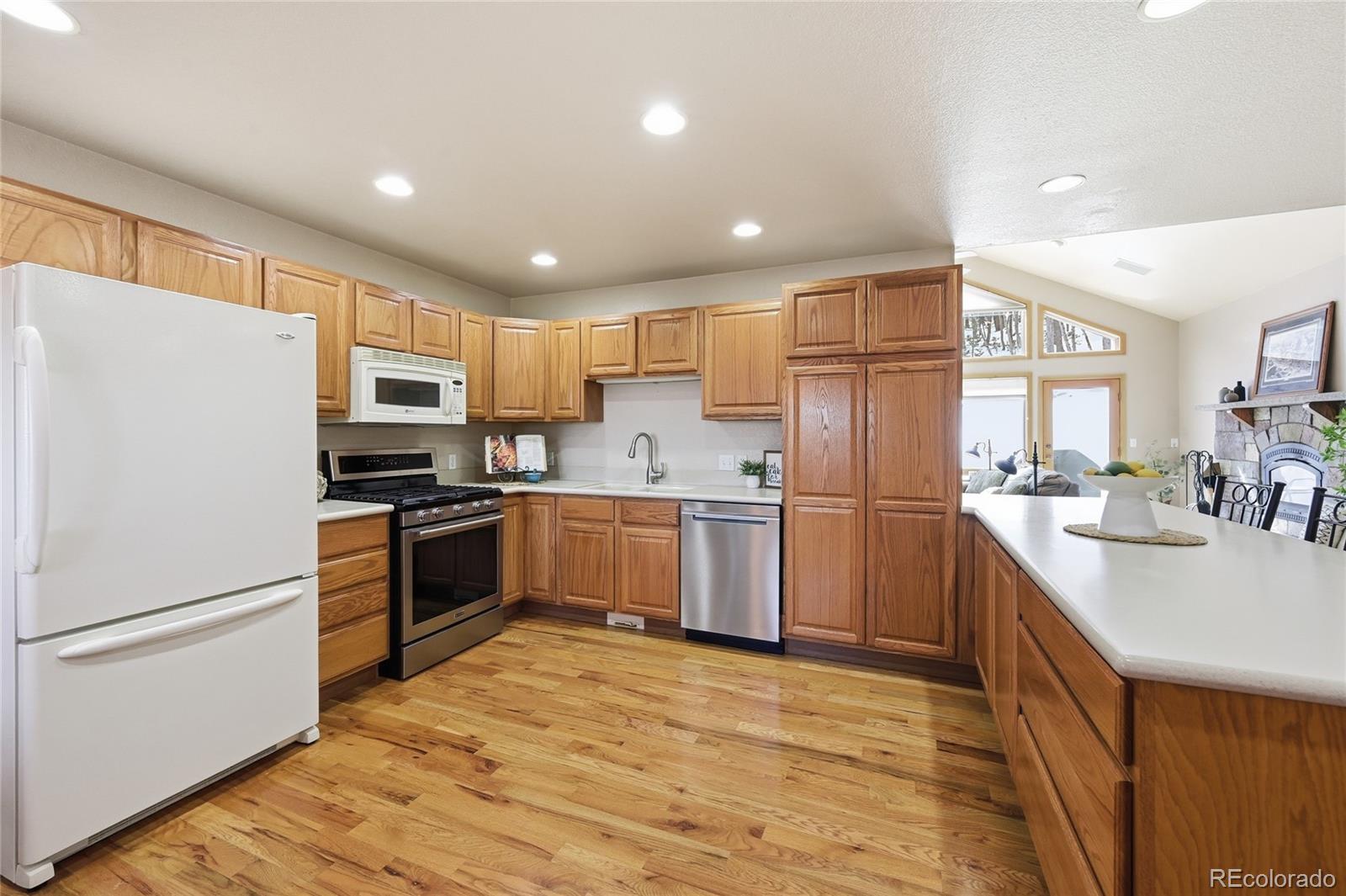 31842 Steven Way Conifer, CO 80433 - Photo 6 of 19 a kitchen with a refrigerator a sink and cabinets