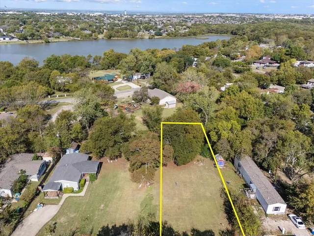 an aerial view of residential houses with outdoor space and river