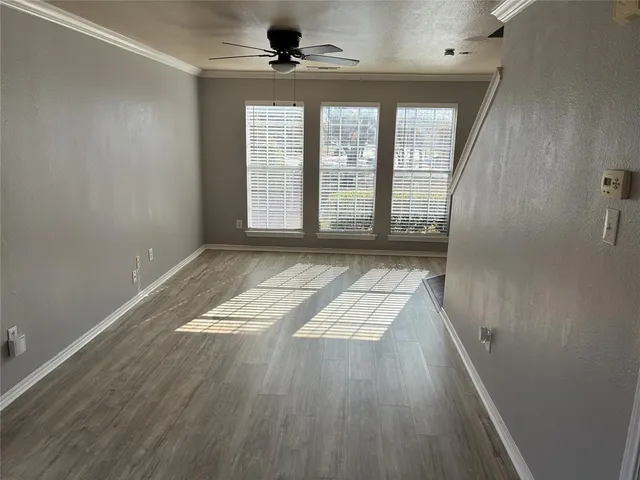 wooden floor in an empty room with a window