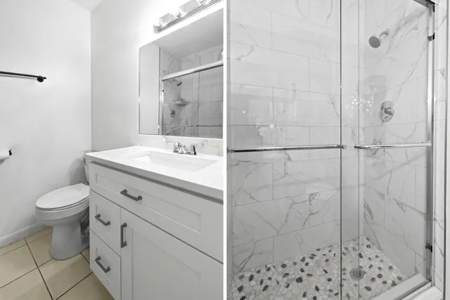 a bathroom with a sink toilet and shower