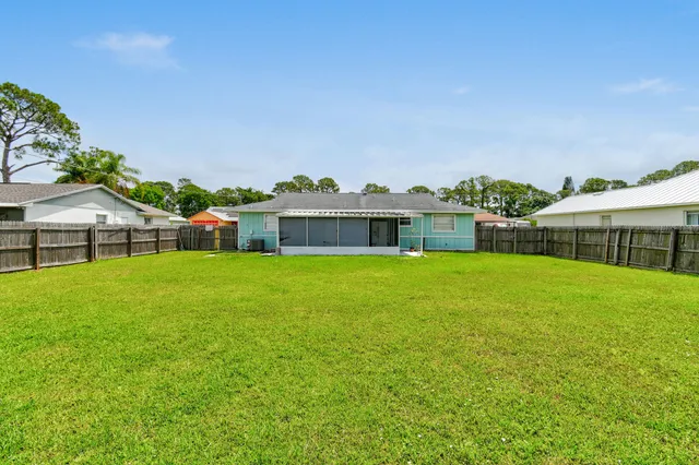 a front view of house with a garden and deck