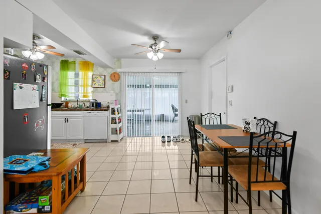 a view of a dining room with furniture and chandelier
