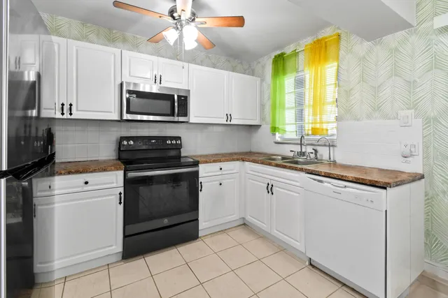 a kitchen with a stove a sink and a microwave