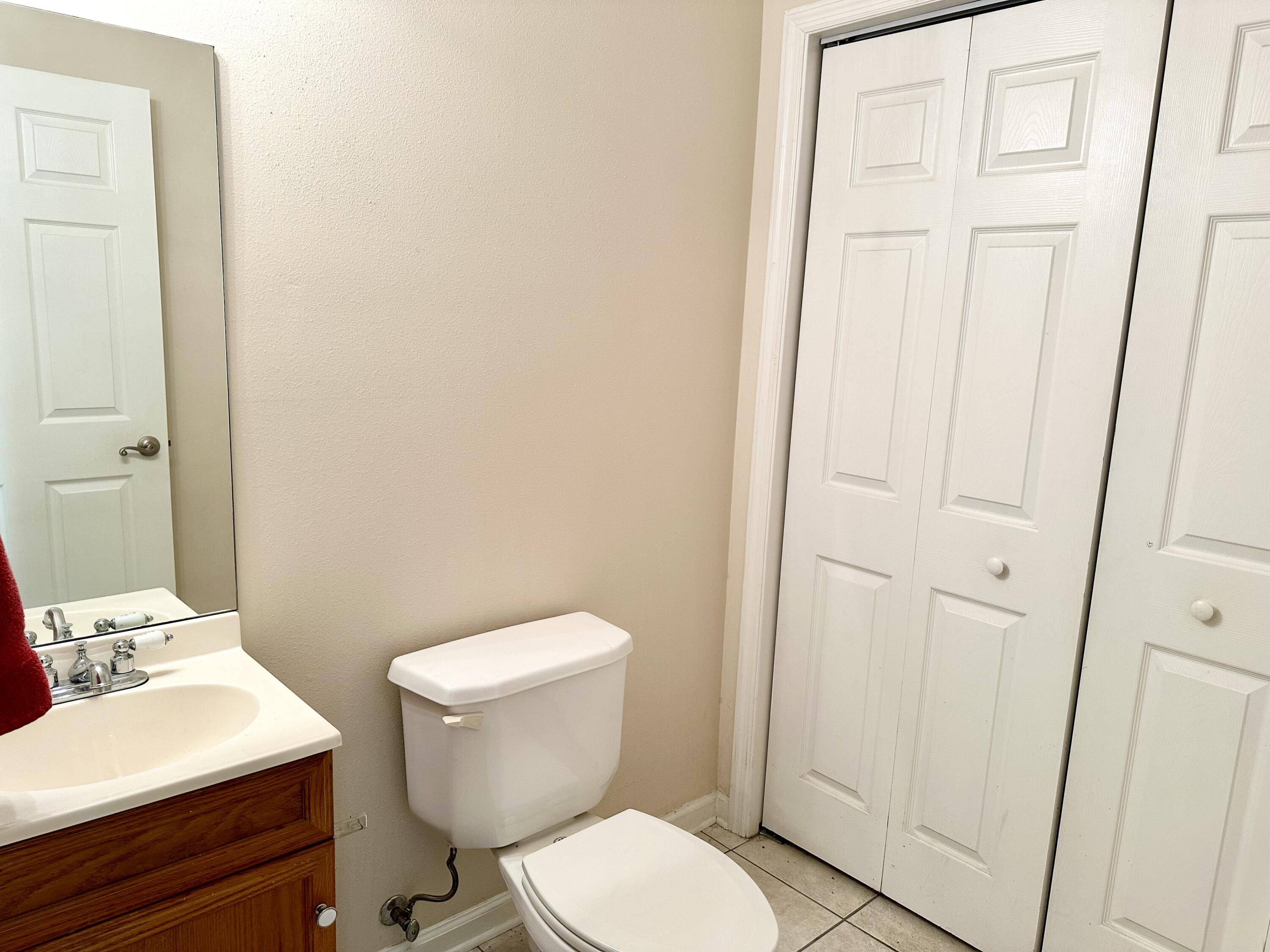 732 East Mack Bayou Drive, Unit 2 Santa Rosa Beach, FL 32459 - Photo 16 of 43 a white toilet sitting next to a bathroom sink
