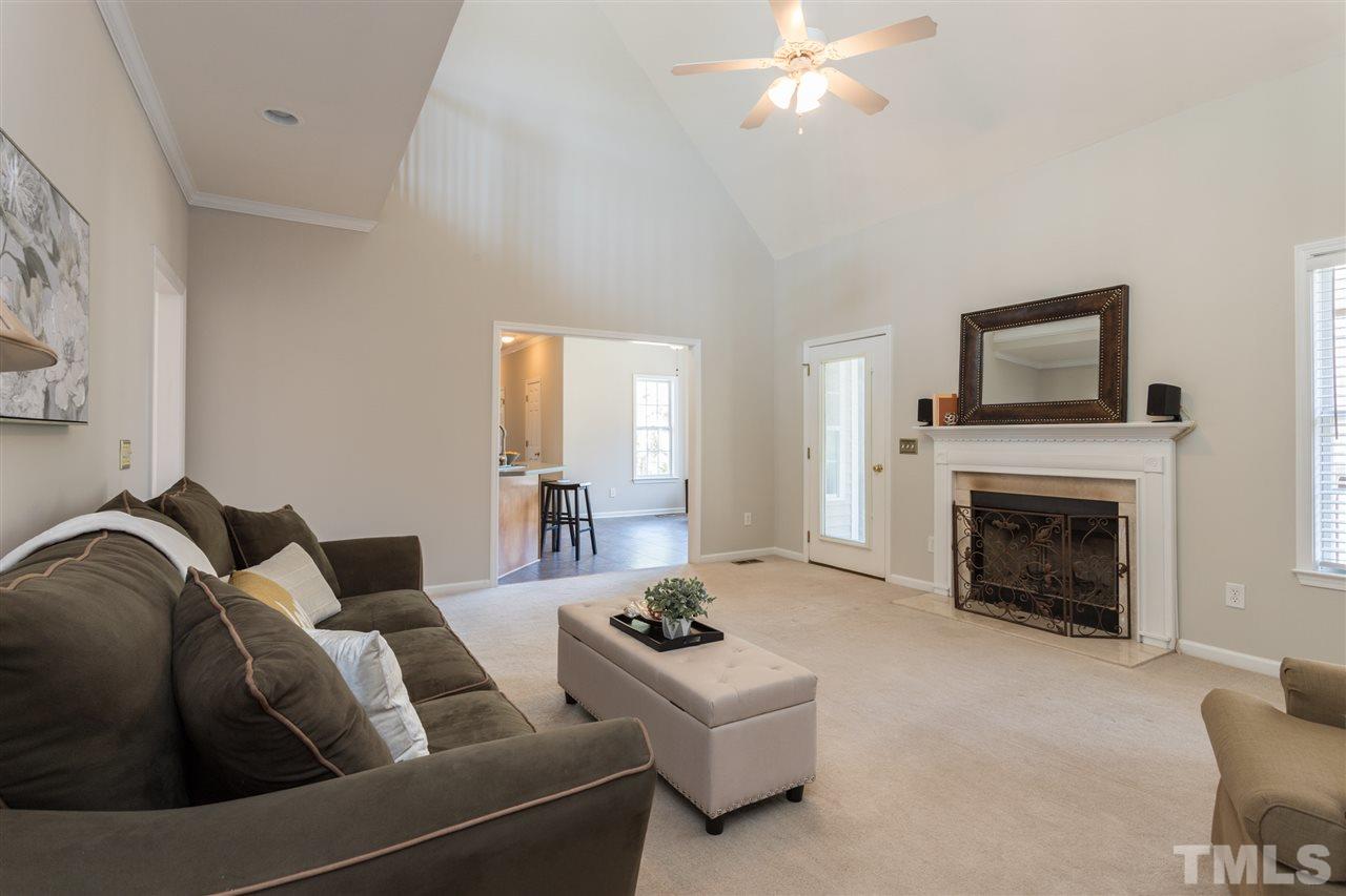 8513 Ridgebury Road Raleigh, NC 27603 - Photo 14 of 30 a living room with furniture and a fireplace