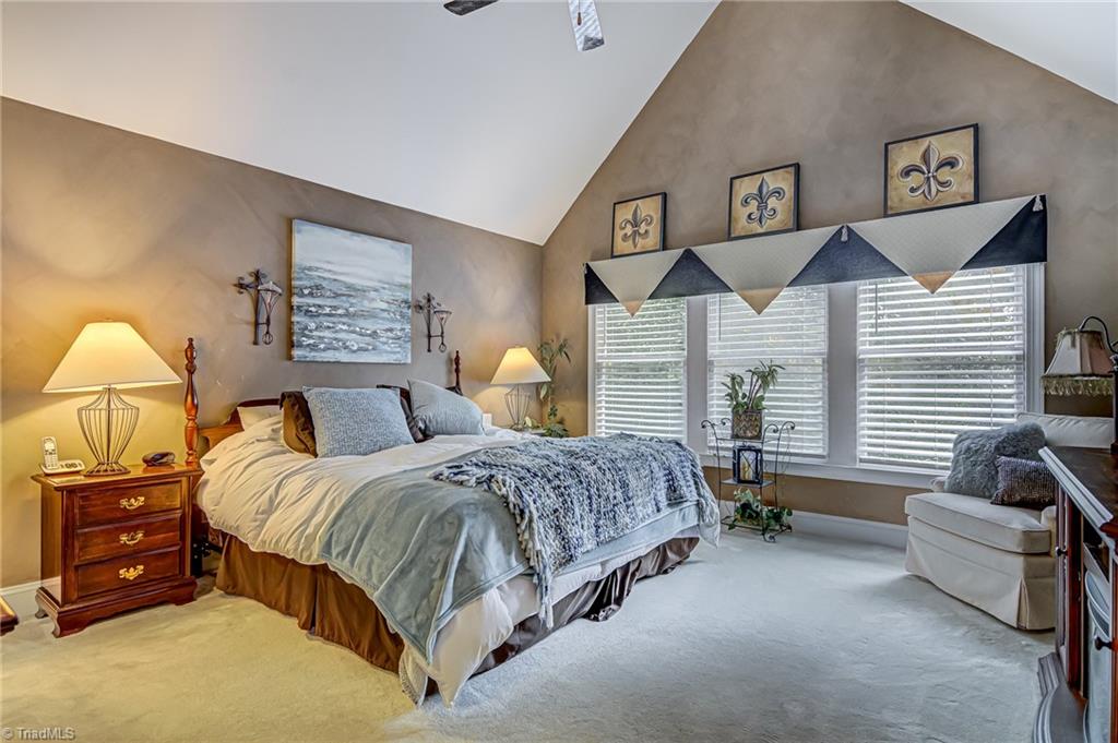 4472 Kendale Road High Point, NC 27265 - Photo 18 of 36 Large primary bedroom with vaulted ceiling, large windows, ceiling fan, walk-in-closet, and en suite bathroom!