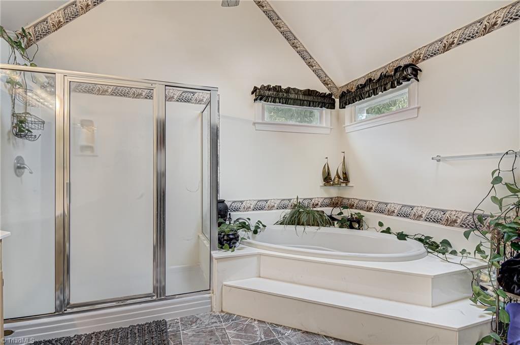 4472 Kendale Road High Point, NC 27265 - Photo 21 of 36 Primary ensuite bathroom boasts garden tub and separate standing shower.