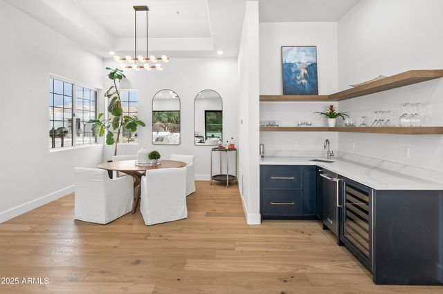 a spacious bedroom with a bed a window and a flat screen tv