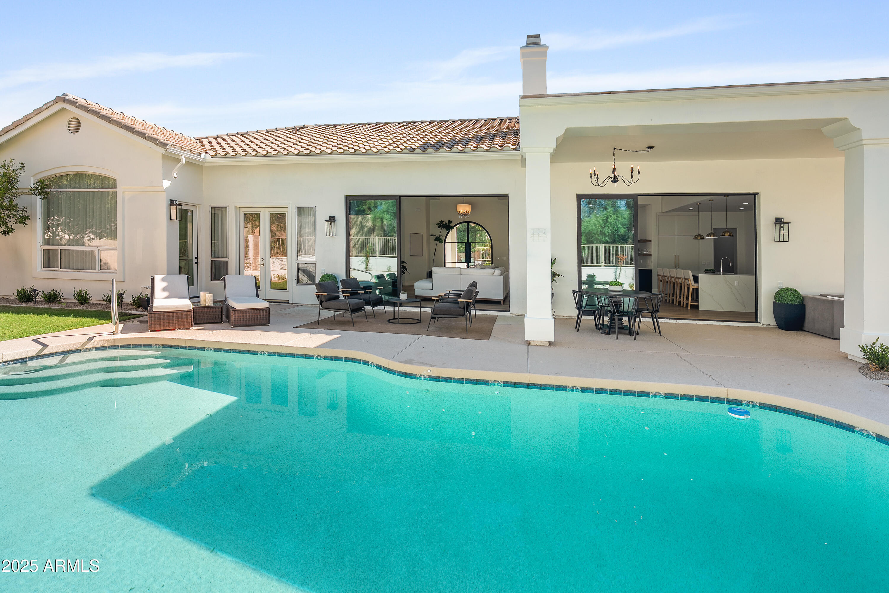 12134 East Mercer Lane Scottsdale, AZ 85259 - Photo 2 of 35 a view of a house with swimming pool and sitting area