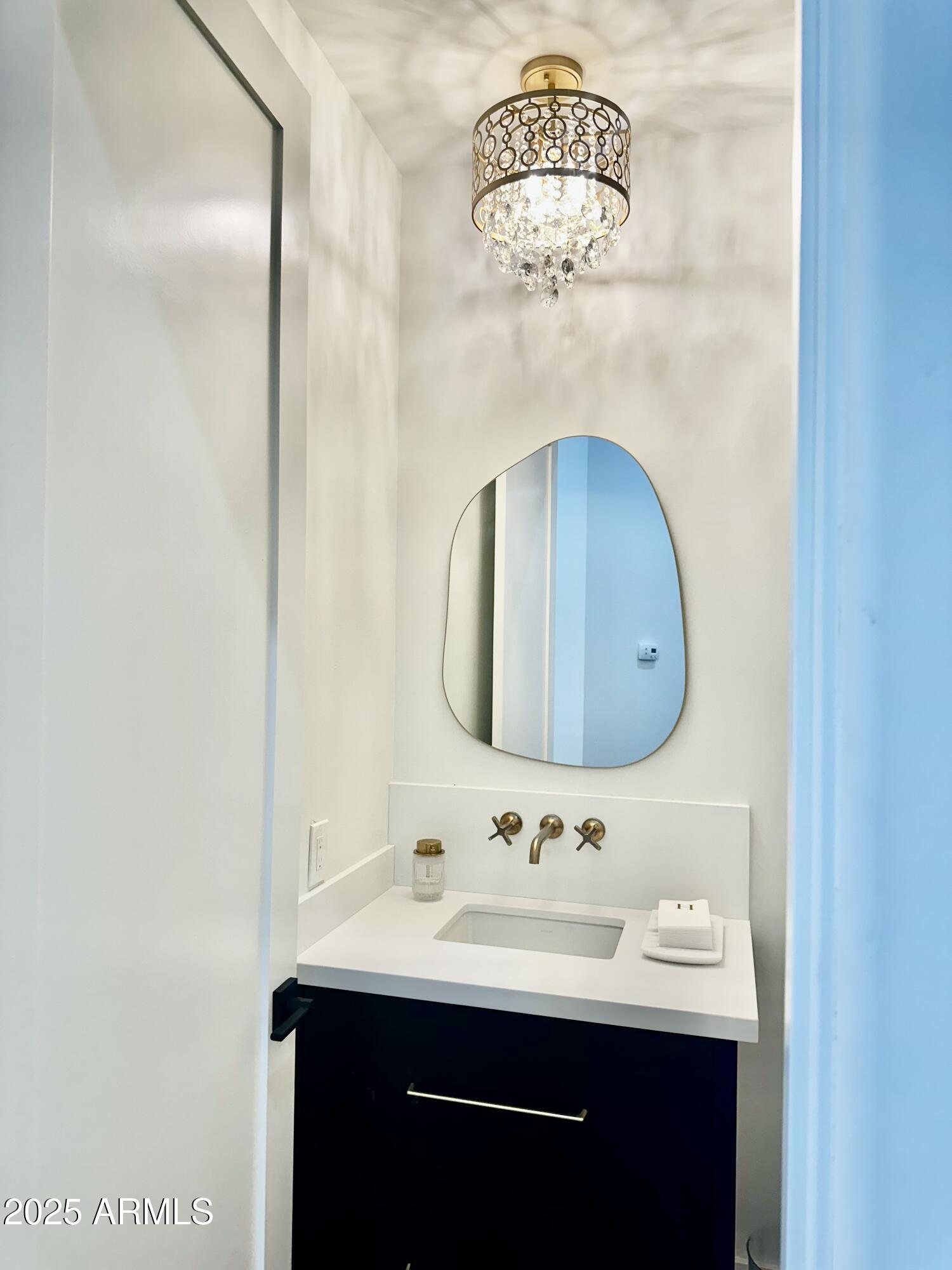 12134 East Mercer Lane Scottsdale, AZ 85259 - Photo 22 of 35 a bathroom with a sink a mirror and vanity