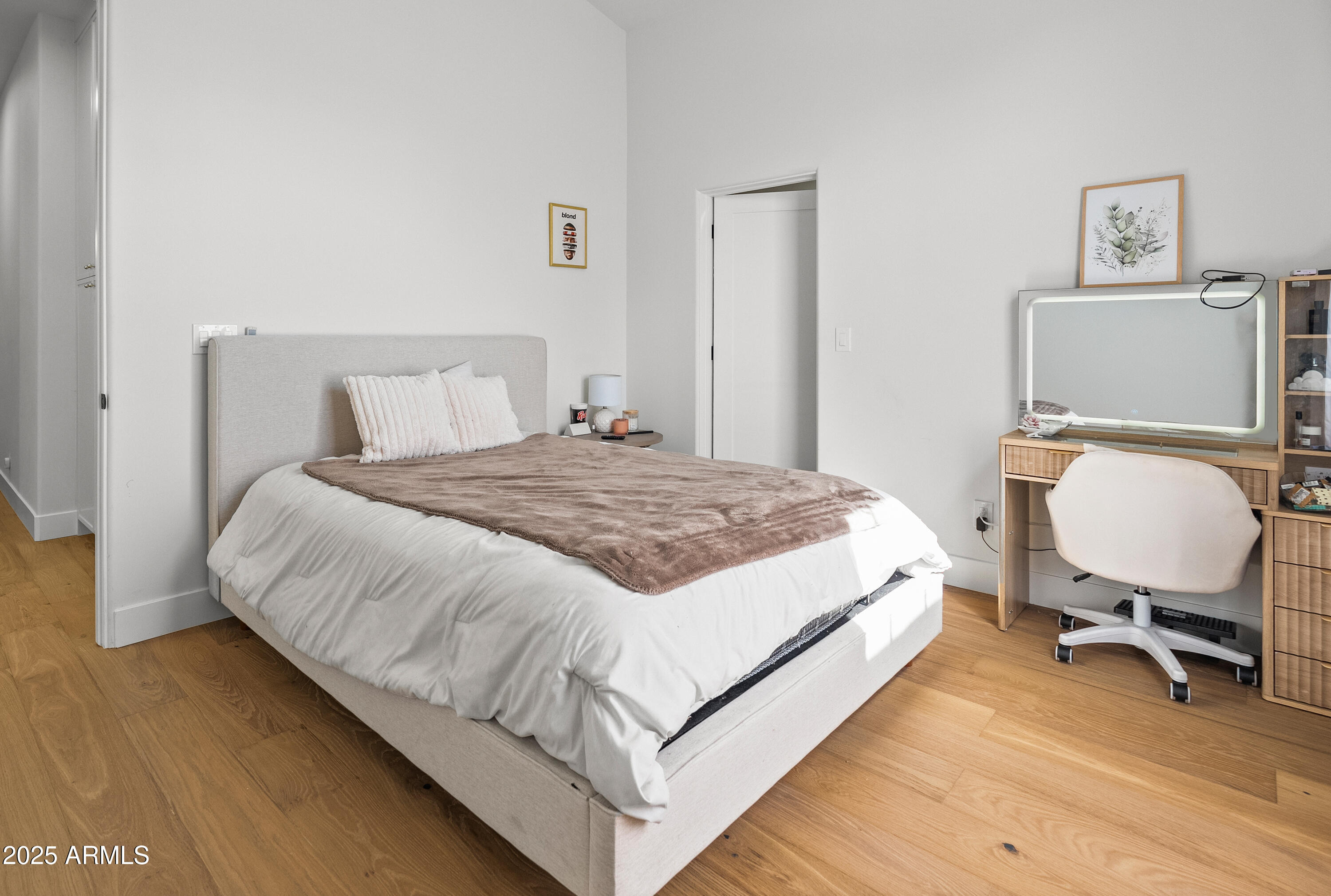 12134 East Mercer Lane Scottsdale, AZ 85259 - Photo 28 of 35 a bedroom with a bed a chair and painting on the wall