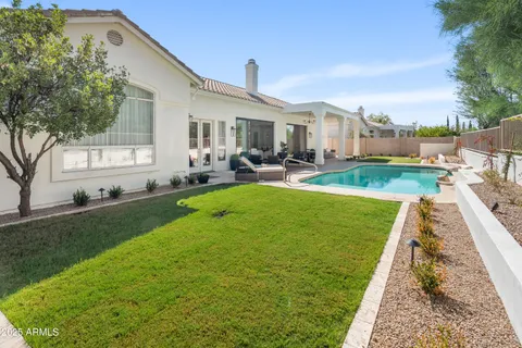a view of a patio with couches chairs and a big yard
