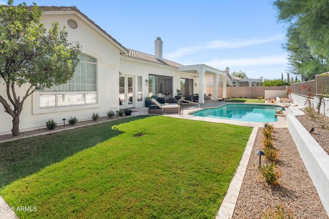 a view of a patio with couches chairs and a big yard