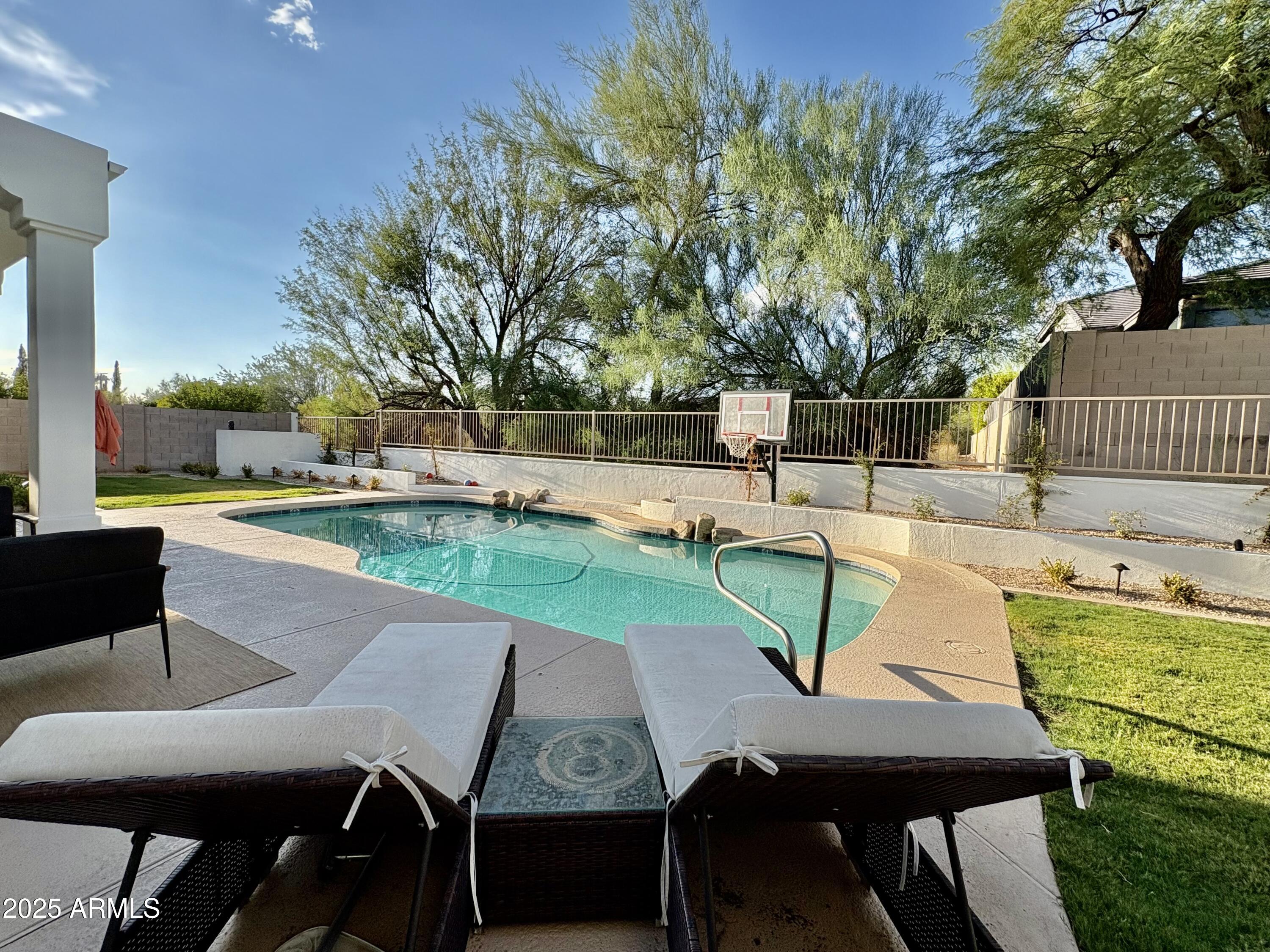 12134 East Mercer Lane Scottsdale, AZ 85259 - Photo 6 of 35 a view of a patio with table and chairs potted plants and large tree