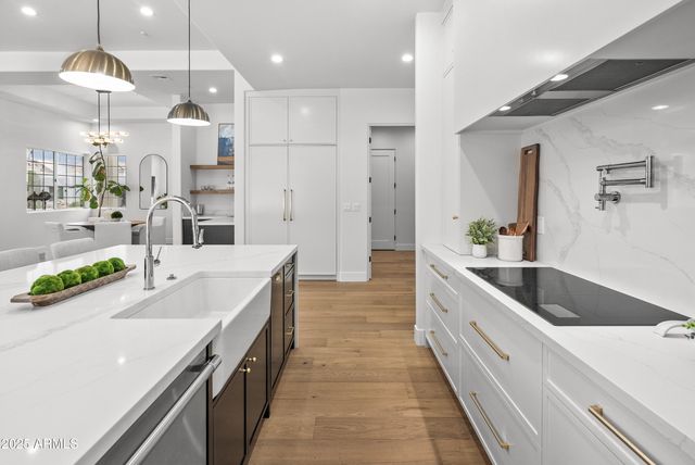 a large kitchen with a table and chairs