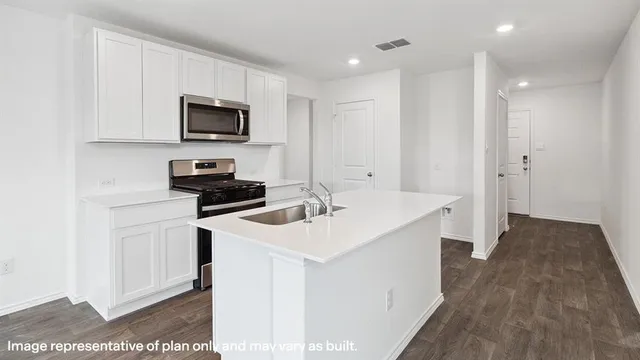 a kitchen with a sink stove and microwave