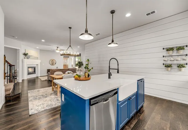 a kitchen with sink and living room view