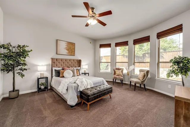 a spacious bedroom with a bed and a large window