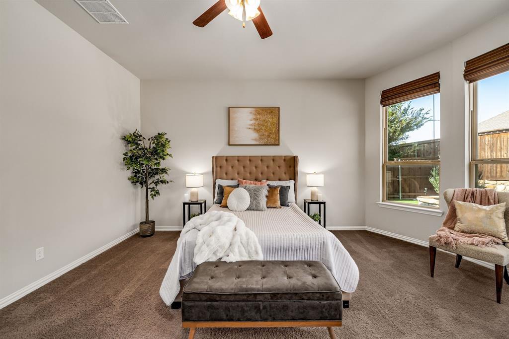 3341 Man O War Road Celina, TX 75009 - Photo 16 of 40 a bed sitting in a bedroom next to a window with potted plant
