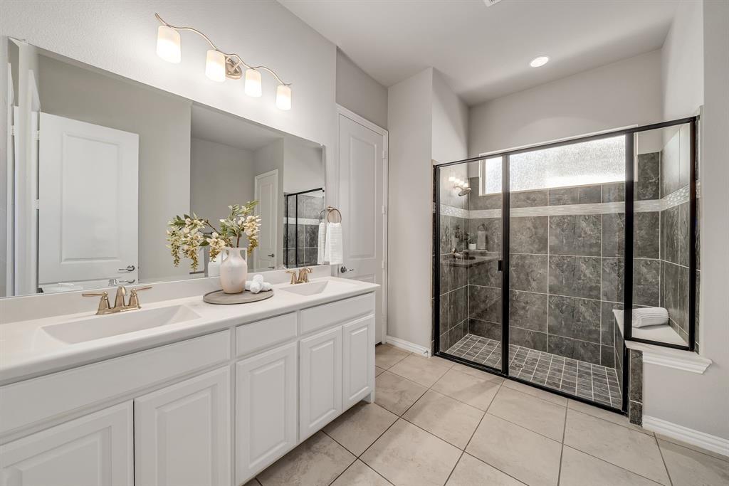 3341 Man O War Road Celina, TX 75009 - Photo 19 of 40 a spacious bathroom with a shower sink and mirror