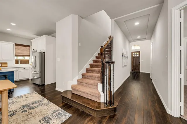 a view of entryway and hall with wooden floor