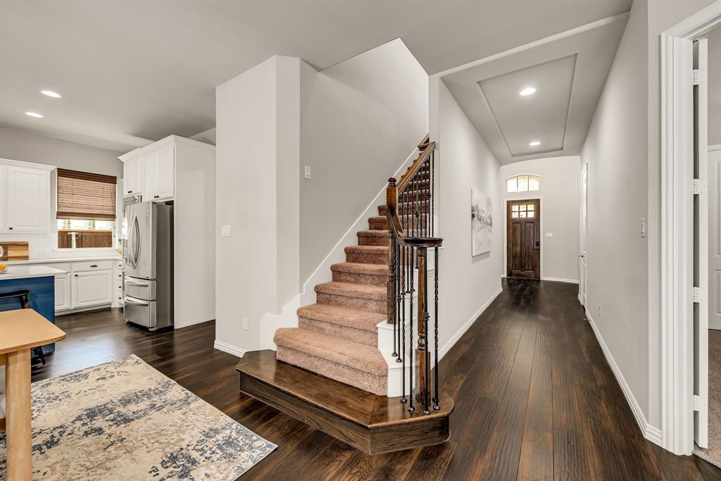 3341 Man O War Road Celina, TX 75009 - Photo 21 of 40 a view of entryway and hall with wooden floor