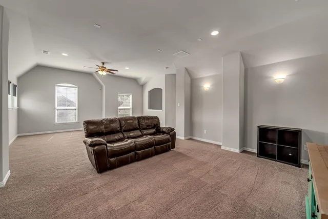 a living room with furniture and a mirror
