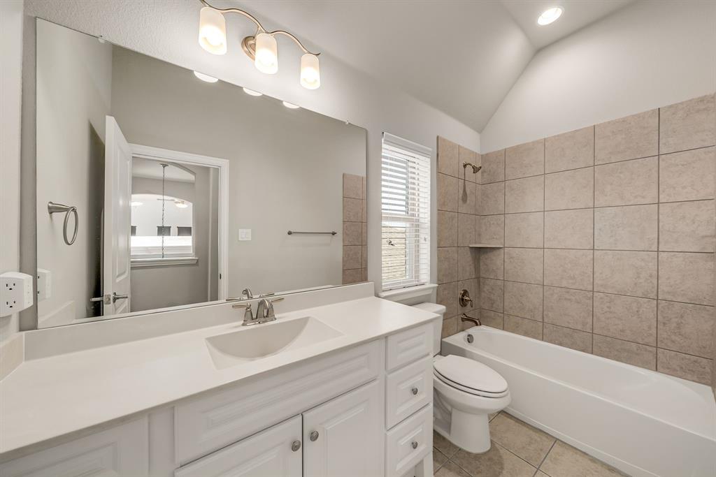 3341 Man O War Road Celina, TX 75009 - Photo 25 of 40 a bathroom with a sink a toilet and shower