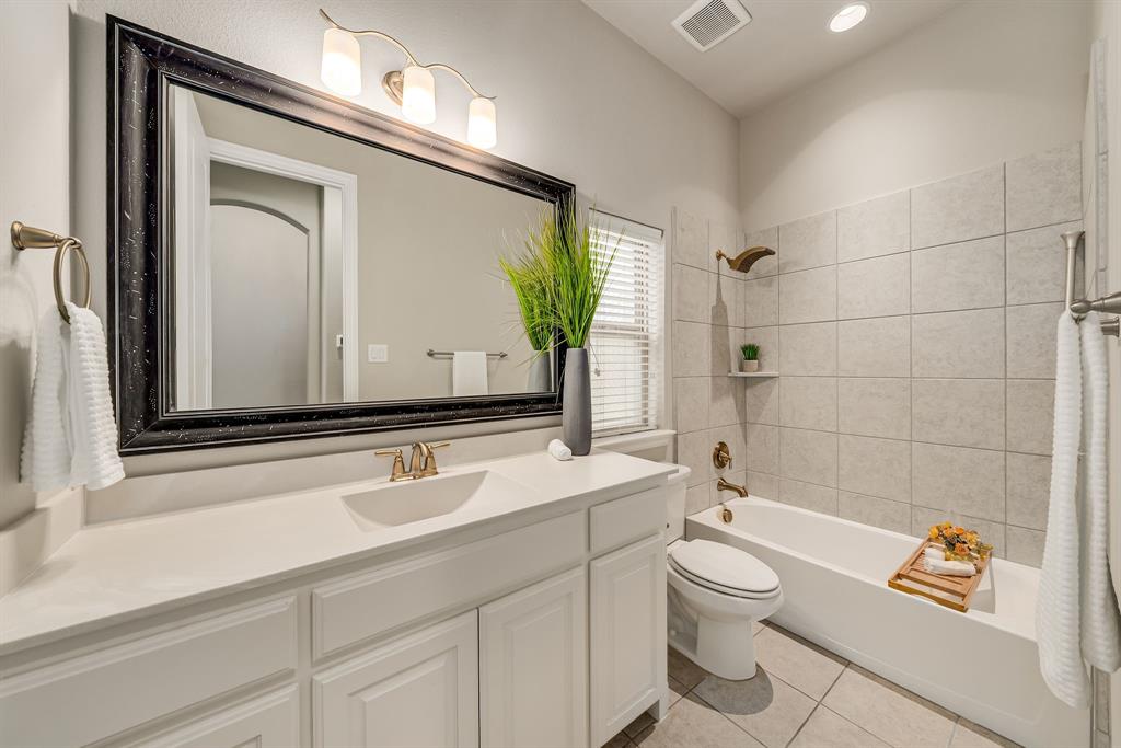 3341 Man O War Road Celina, TX 75009 - Photo 27 of 40 a bathroom with a toilet a sink and a large mirror