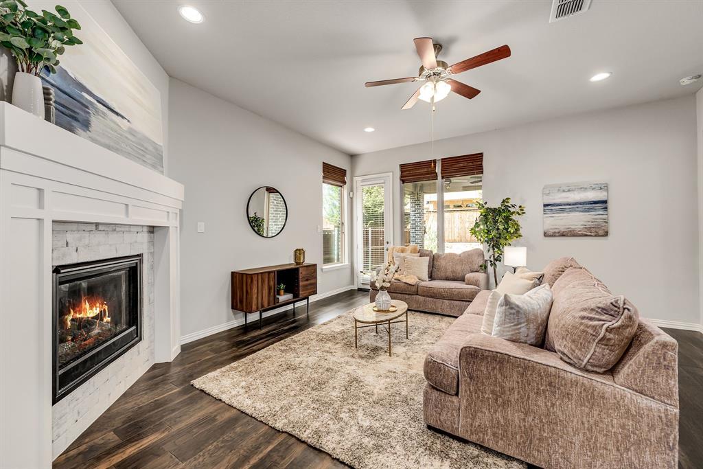 3341 Man O War Road Celina, TX 75009 - Photo 8 of 40 a living room with furniture a fireplace and a large window