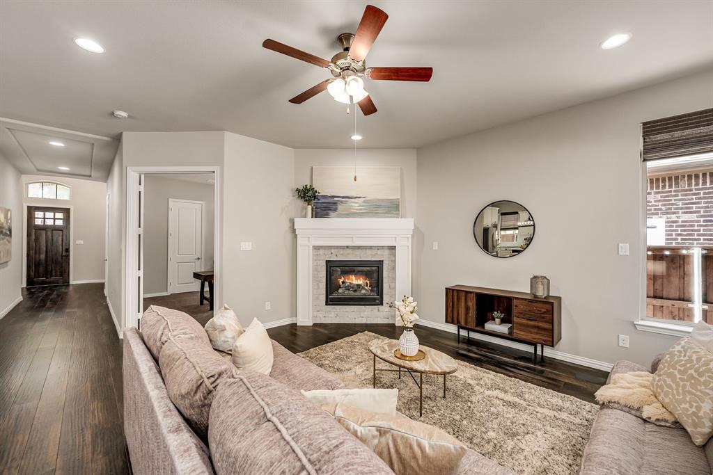 3341 Man O War Road Celina, TX 75009 - Photo 9 of 40 a living room with furniture a fireplace and a chandelier
