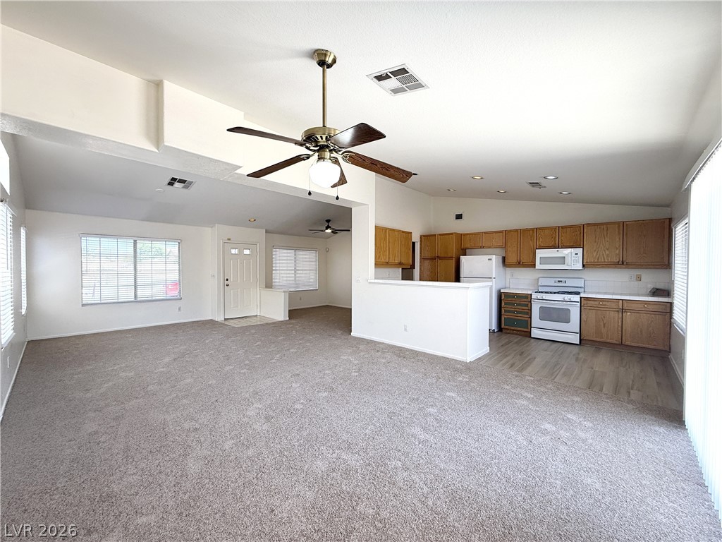 8870 Haviland Road Las Vegas, NV 89123 - Photo 22 of 22 An open floorplan seamlessly connects the living area to a practical kitchen, creating an inviting space for daily life.