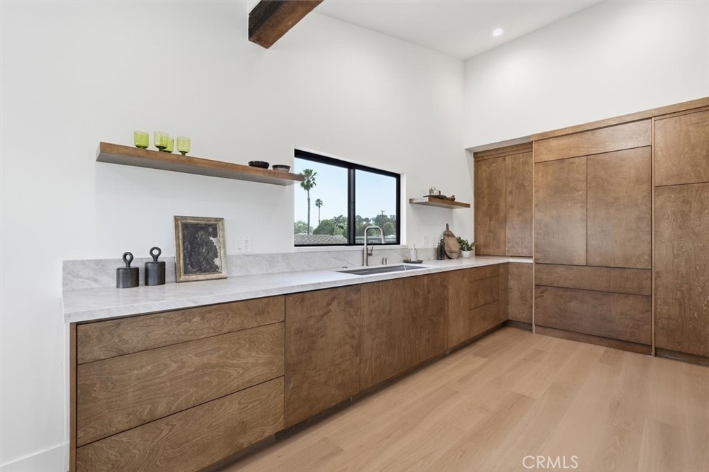 8140 Calabar Avenue Playa del Rey, CA 90293 - Photo 14 of 59 a large white kitchen with a sink and dishwasher a stove with wooden floor