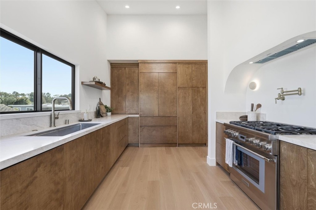 8140 Calabar Avenue Playa del Rey, CA 90293 - Photo 15 of 59 a large kitchen with stainless steel appliances granite countertop a lot of counter space and a sink