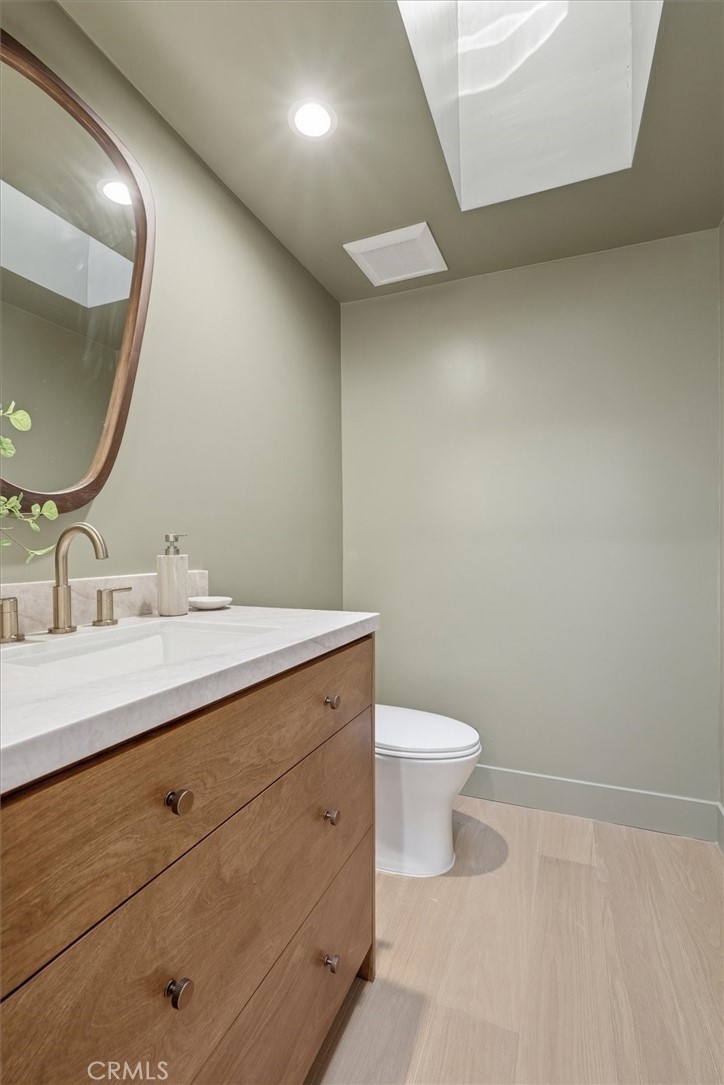8140 Calabar Avenue Playa del Rey, CA 90293 - Photo 24 of 59 a bathroom with a granite countertop sink a toilet and a mirror