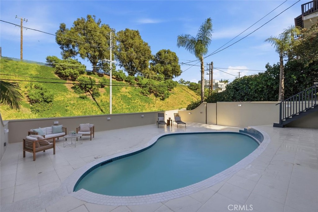 8140 Calabar Avenue Playa del Rey, CA 90293 - Photo 49 of 59 a view of a swimming pool with a lounge chair