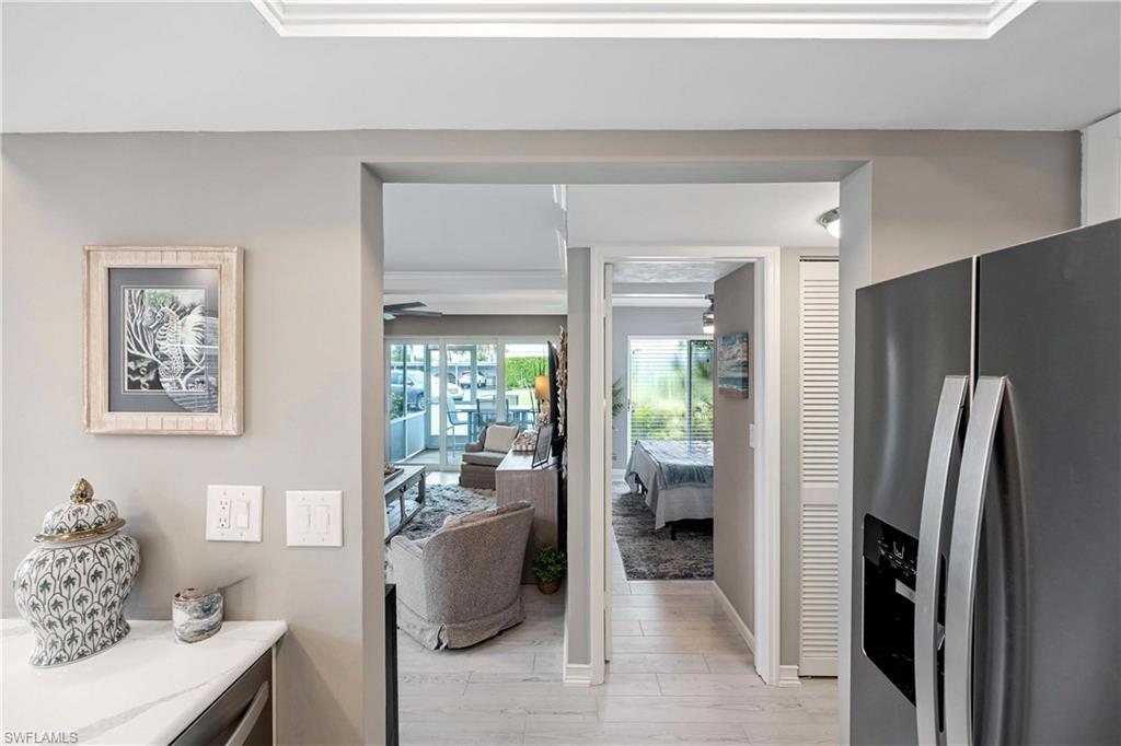330 Kon Tiki Drive, Unit C7 Naples, FL 34113 - Photo 12 of 50 a living room with furniture and a window