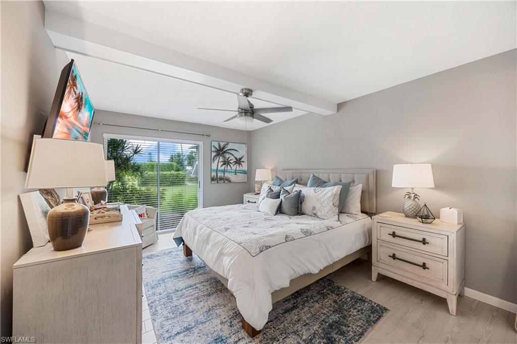 330 Kon Tiki Drive, Unit C7 Naples, FL 34113 - Photo 13 of 50 a bedroom with a bed and a couch