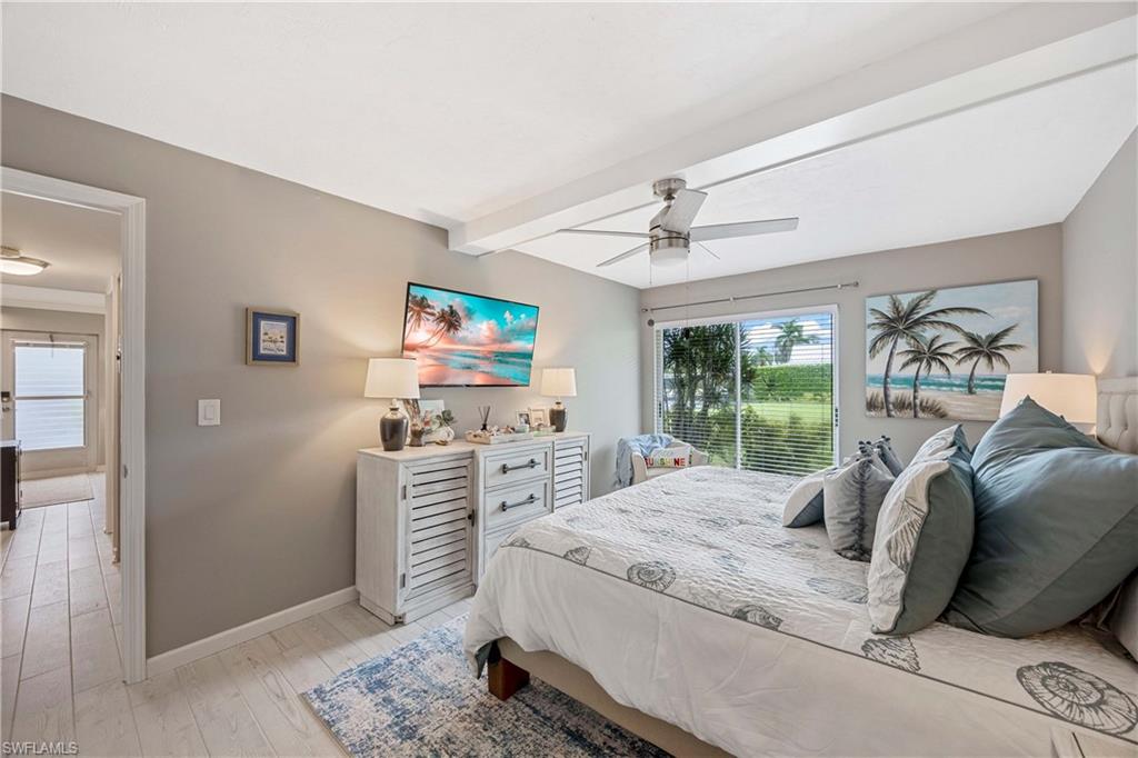 330 Kon Tiki Drive, Unit C7 Naples, FL 34113 - Photo 14 of 50 a living room with furniture and a flat screen tv
