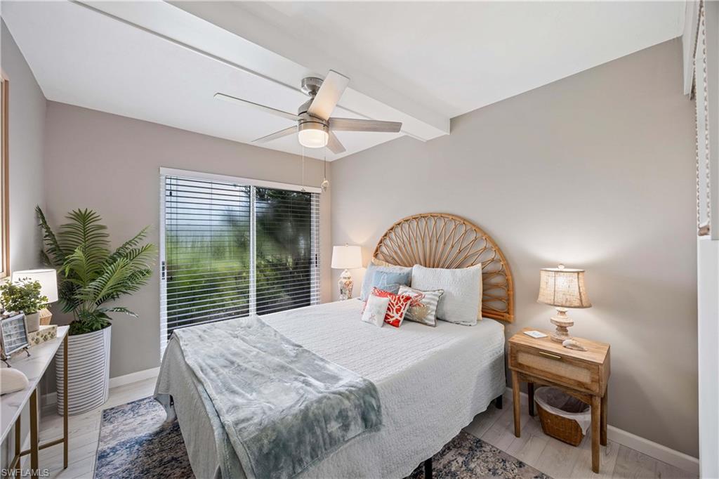 330 Kon Tiki Drive, Unit C7 Naples, FL 34113 - Photo 17 of 50 a bedroom with a bed and a large window
