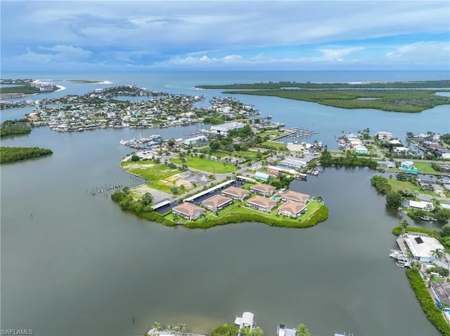 an aerial view of a house with a lake view